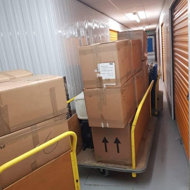 there are packed boxes of stuff placed in a trolley in the storage section