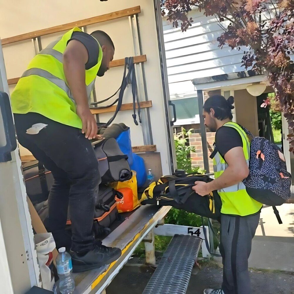 two workers of our company are unloading stuff from the van
