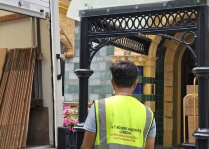 24/7 Movers Packers London staff member standing near moving truck outside Taj 51 Buckingham Gate Suites and Residences, preparing for luxury removals service in Central London.